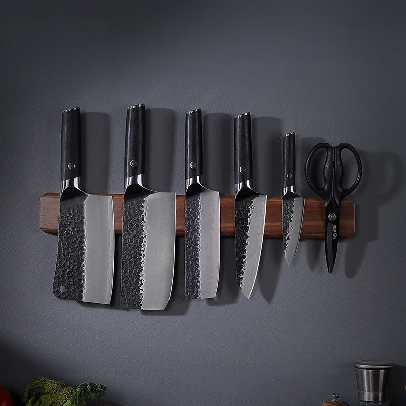 Knives on wall-mounted wooden magnetic rack