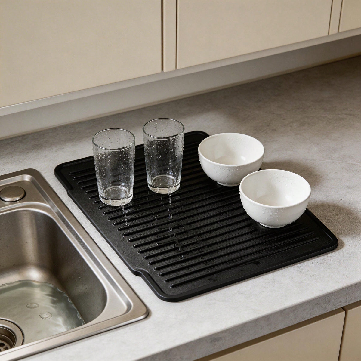 Black silicone drying mat with glasses and bowls