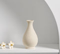 Cream ceramic vase with dried flowers