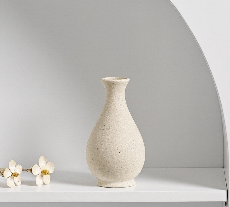 Cream ceramic vase with dried flowers