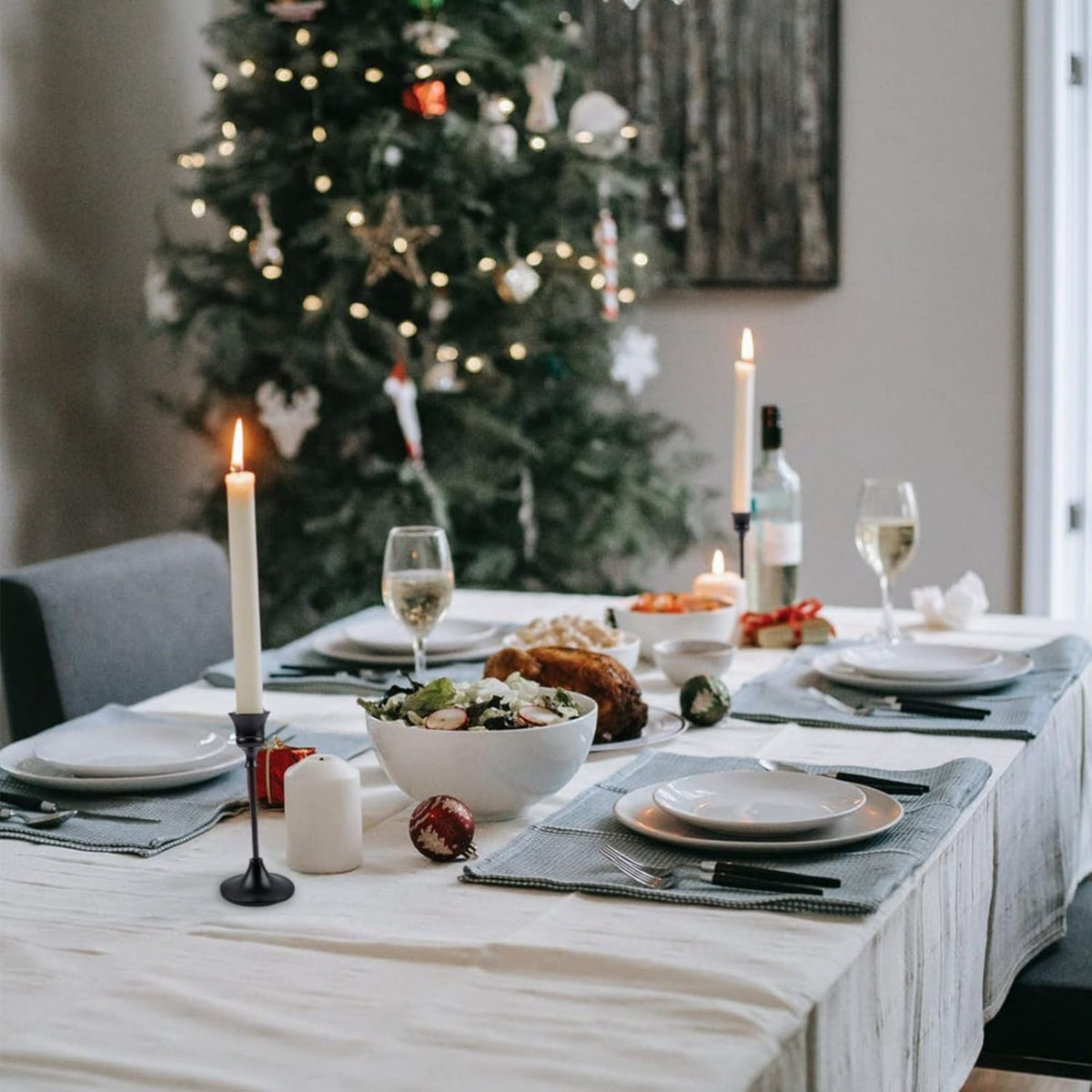 Black metal candlesticks on a festive dinner table